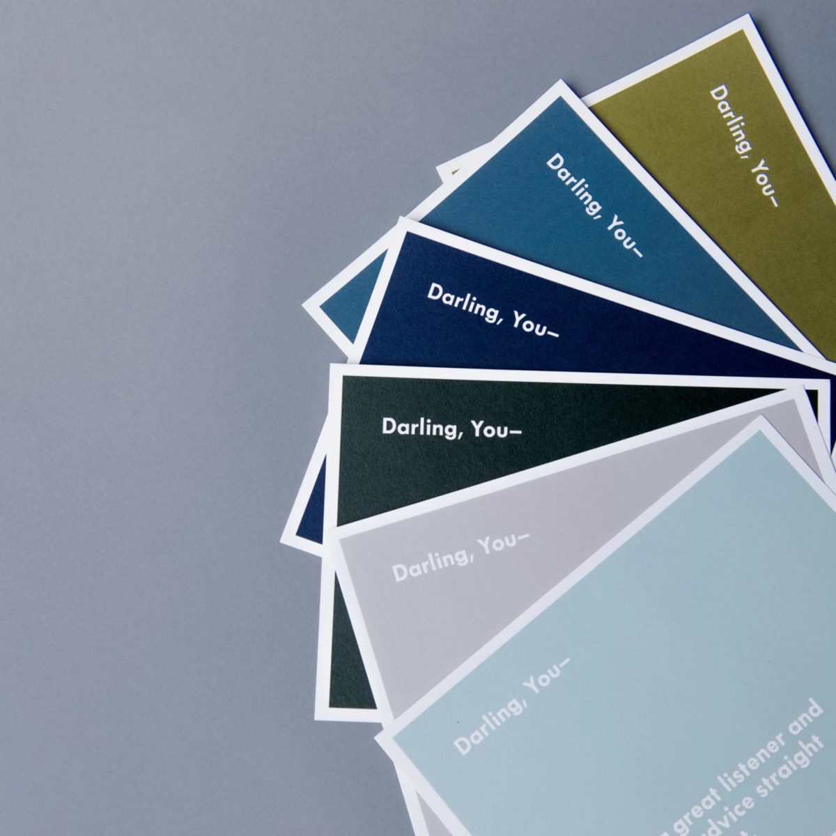 A set of cards splayed out on a table that say, "Darling, You-"