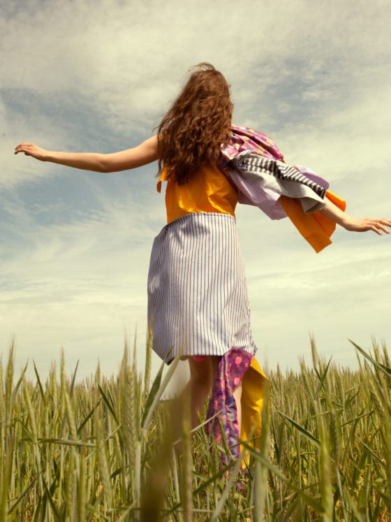 A girl prancing through tall grass
