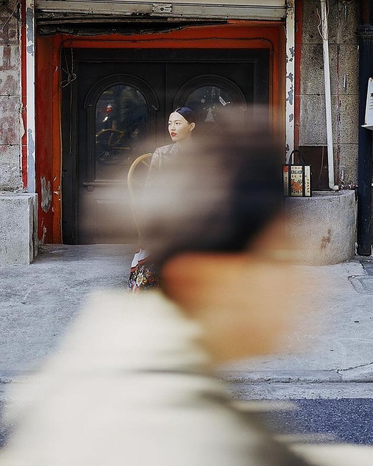 An image of a blurred passerby in front of a woman