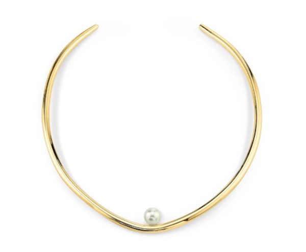 A gold choker necklace with one pearl