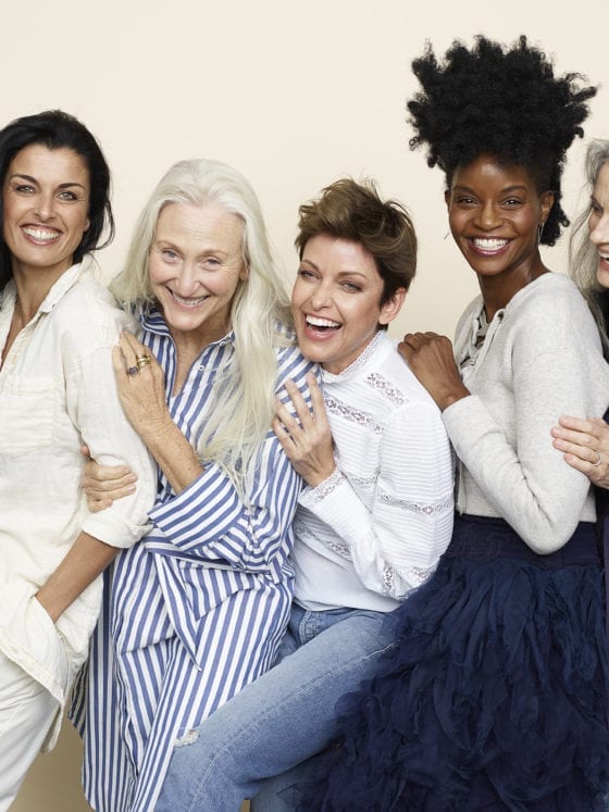 A group of diverse women smiling and laughing at the camera
