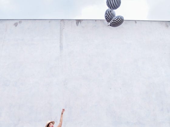 A woman releasing balloons into the air