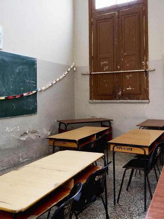 A photo of an empty classroom with desks