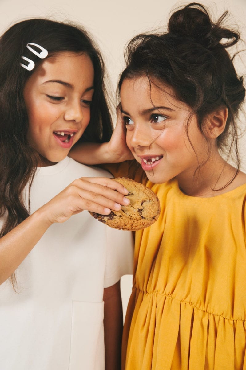 Two girl eating a cookie