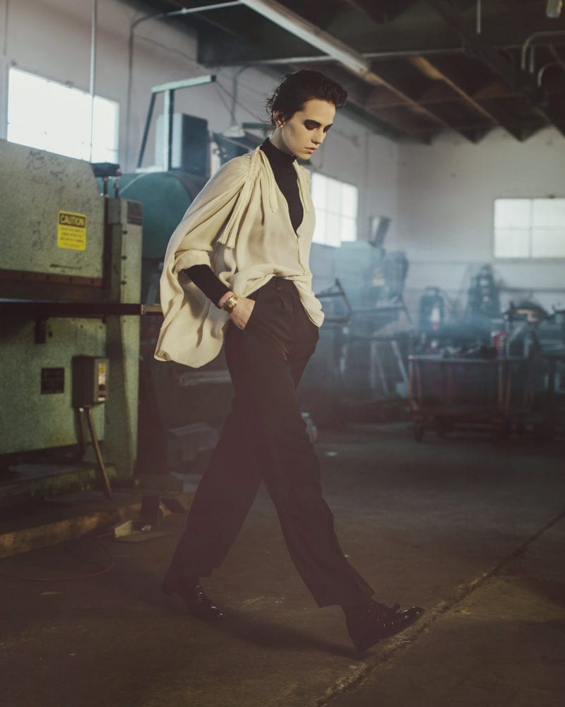 A woman walking in a warehouse looking downward