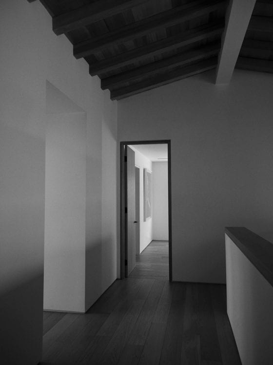 A dark hallway with an open door