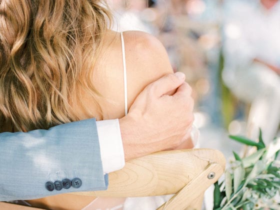 A photo of a man's arm around his bride
