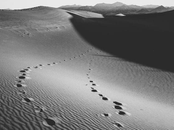 A picture of footprints in the sand in the desert