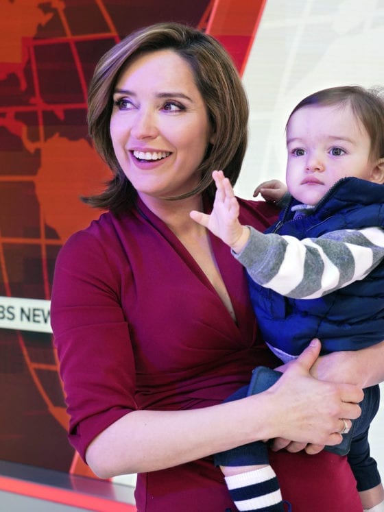 A woman holding her son at a news recording studio