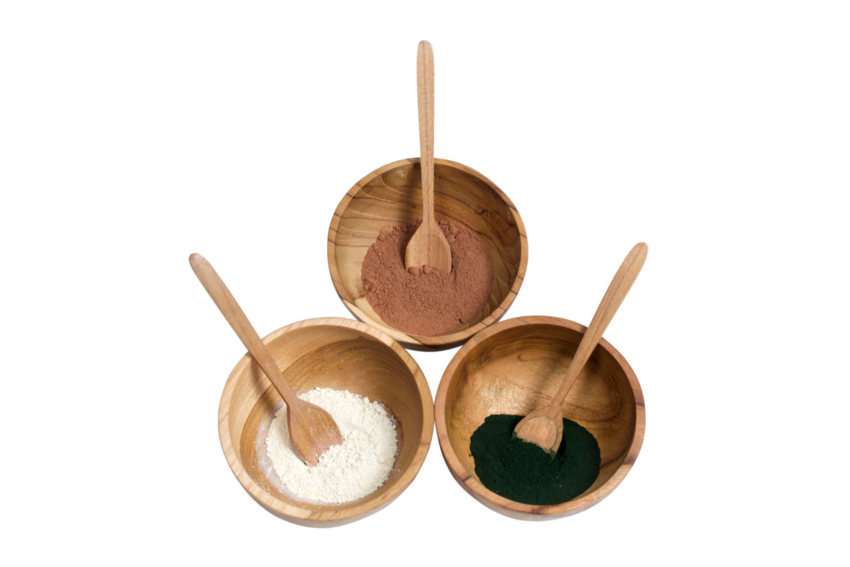 Three wooden mixing bowls and a spoon