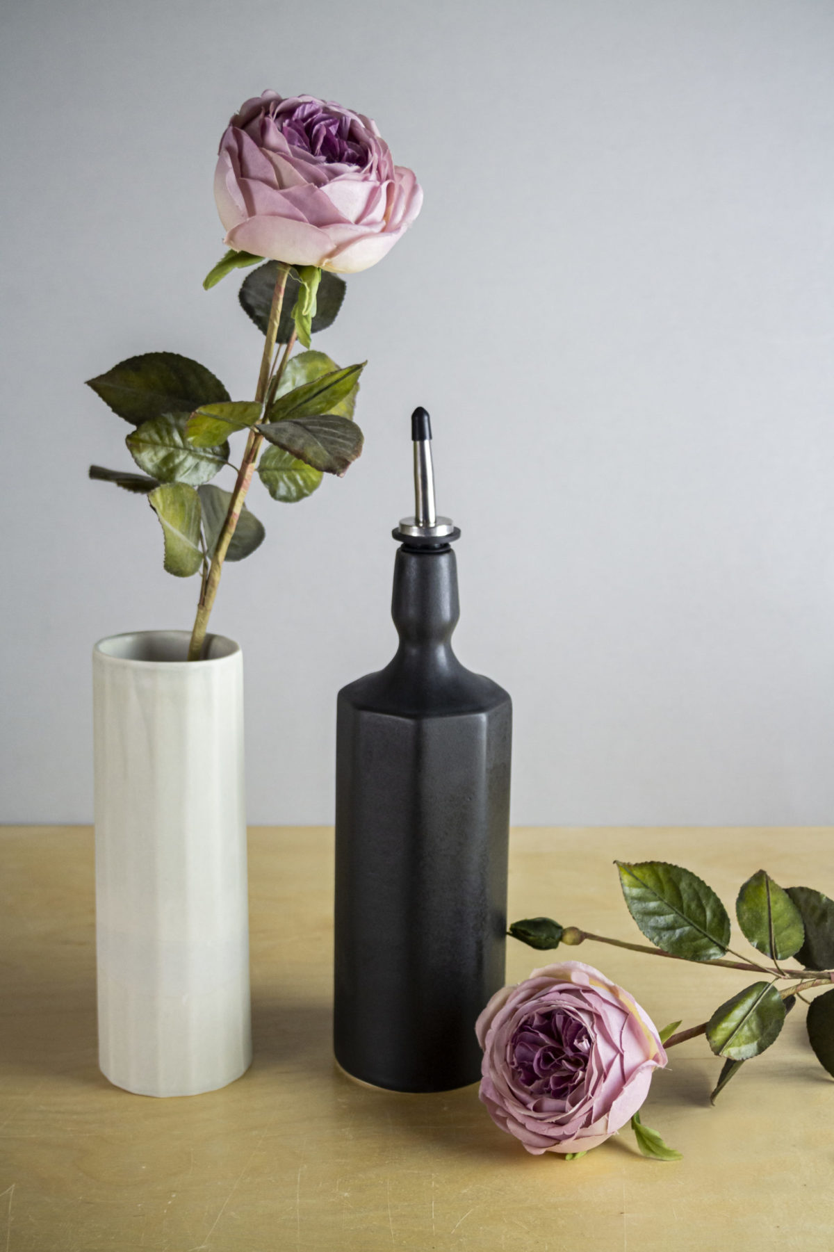 An oil bottle next to flowers