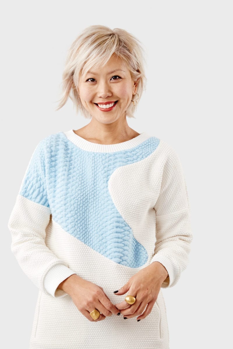 A woman in a blue and cream sweater