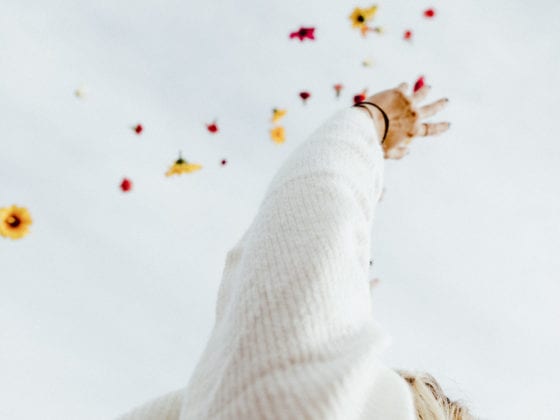 A woman throwing flowers into the sky