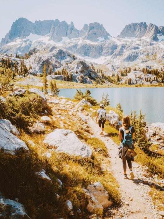 Two women backpacking through the mountains
