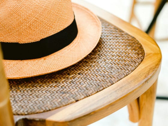A straw hat on a wooden chair