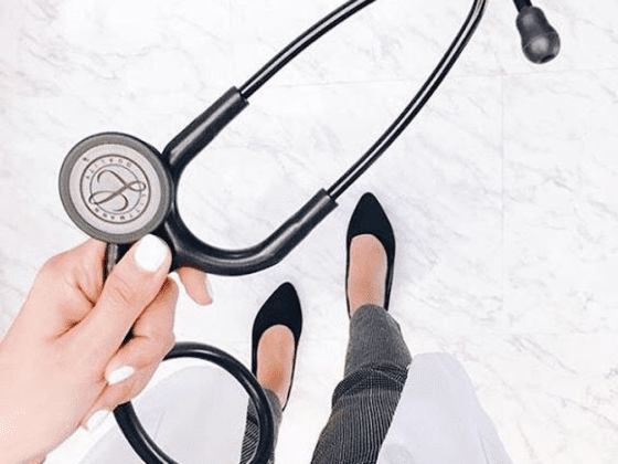 A picture of a woman's hand holding a stethoscope