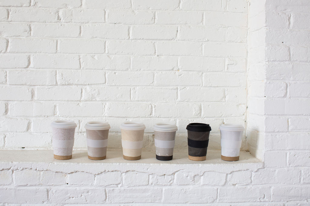 a picture of several coffee mugs against a white wall