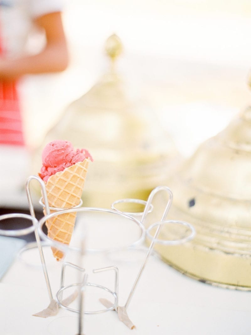 An ice cream cone placed in a holder on a table