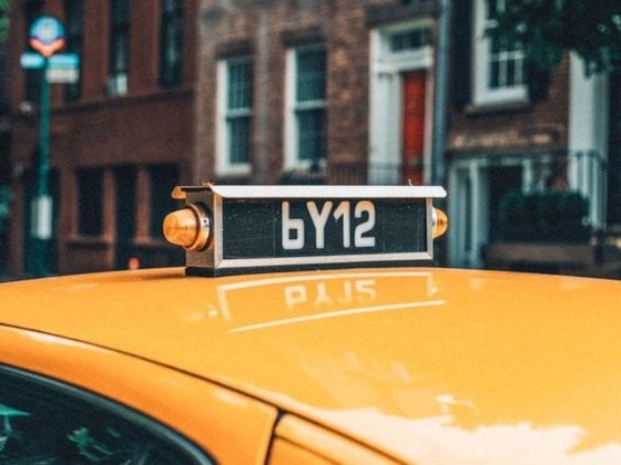 A picture of a the top of a cab driving through New York City
