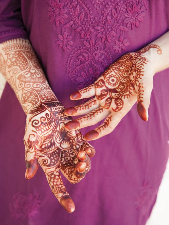 A woman with henna tattoos on her hands