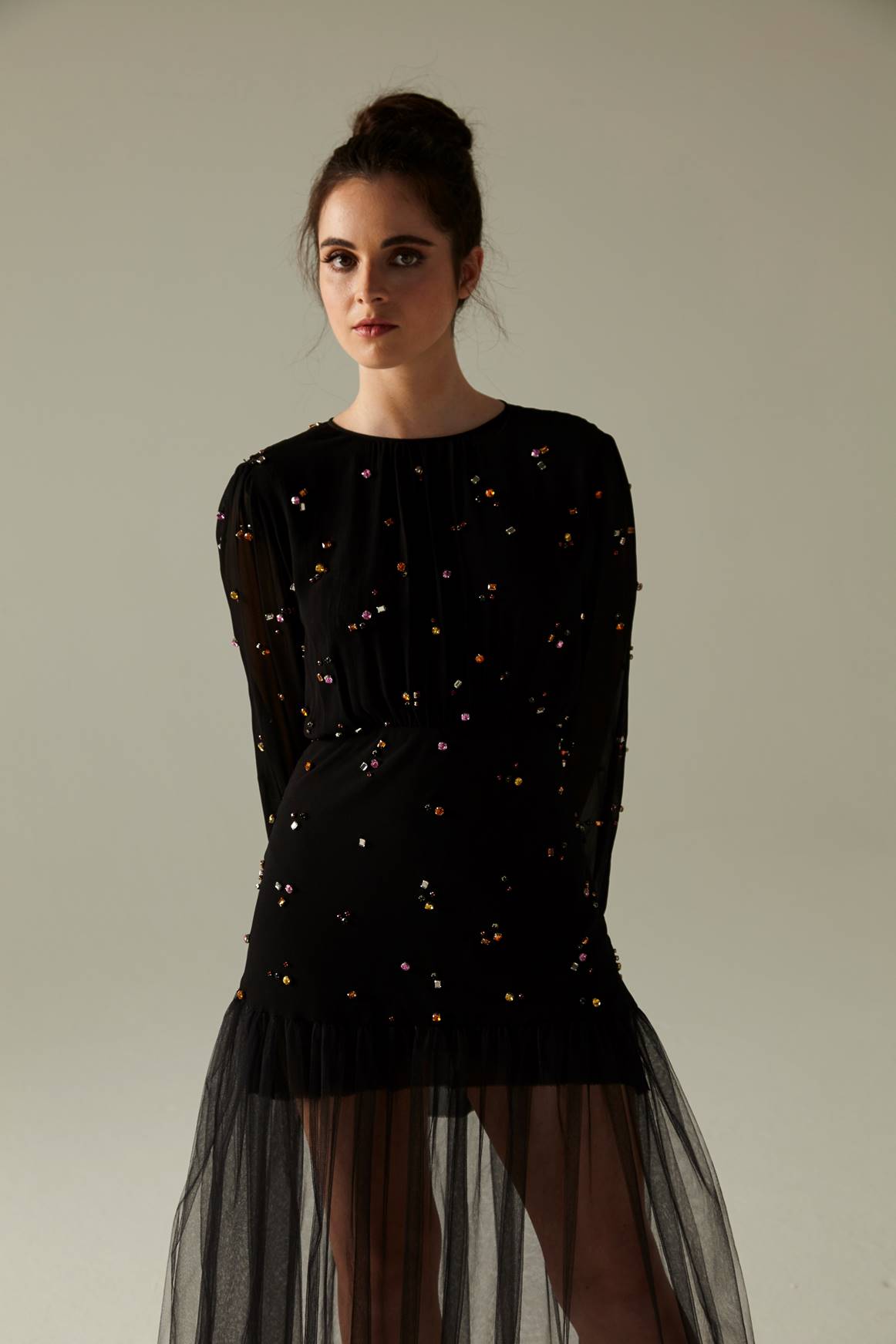 A picture of a woman in a black dress with a sequin bottom