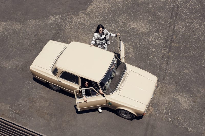 An aerial view of two women getting out of a car