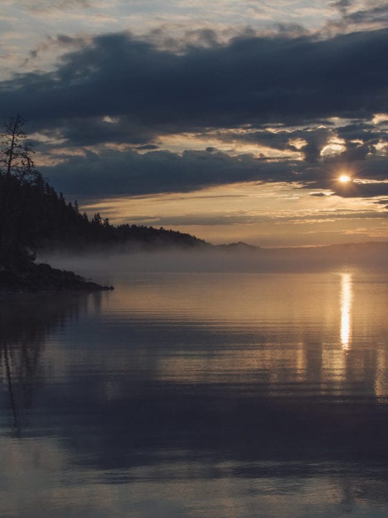A sunrise over a lake