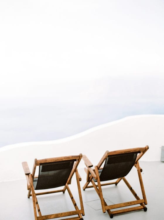 Two empty seats near an ocean shore
