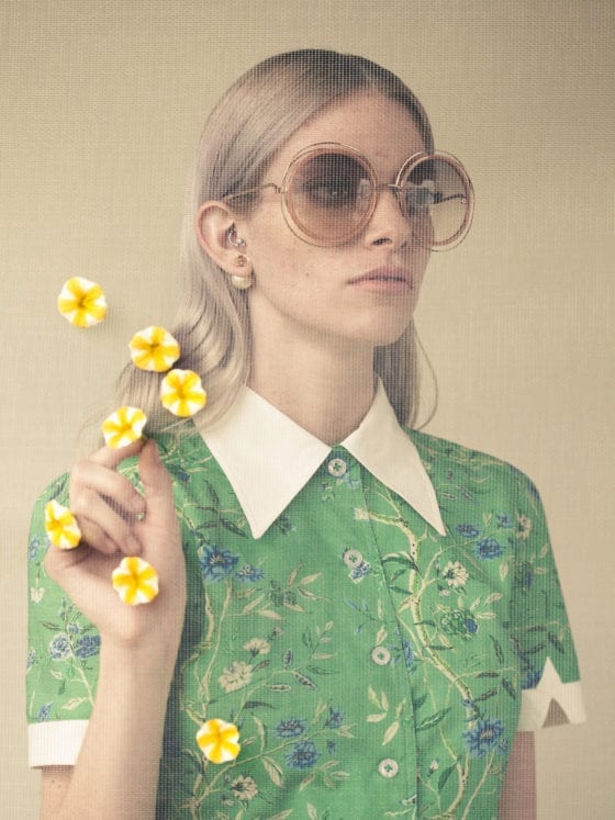 A woman with sunglasses holding flower petals