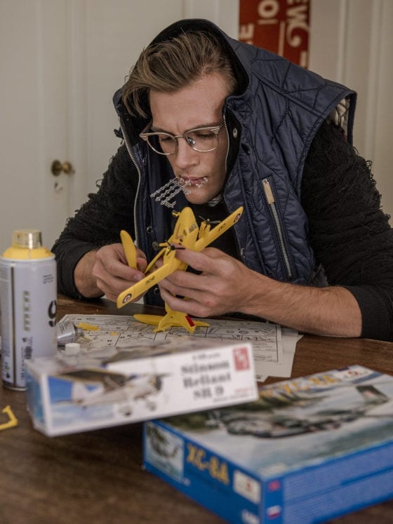 A man at a table with measuring tape and rulers