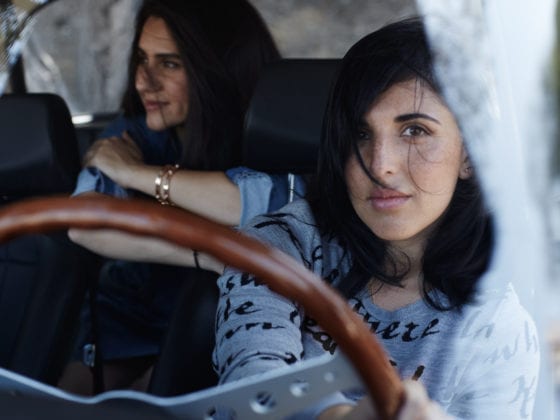Two women in a car, one in the driver's seat
