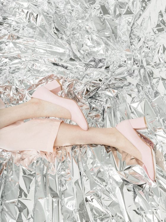 A woman's feet in heels on aluminum foil