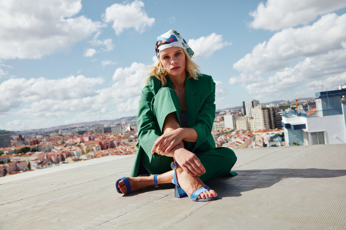 A woman modeling shoes on a rooftop